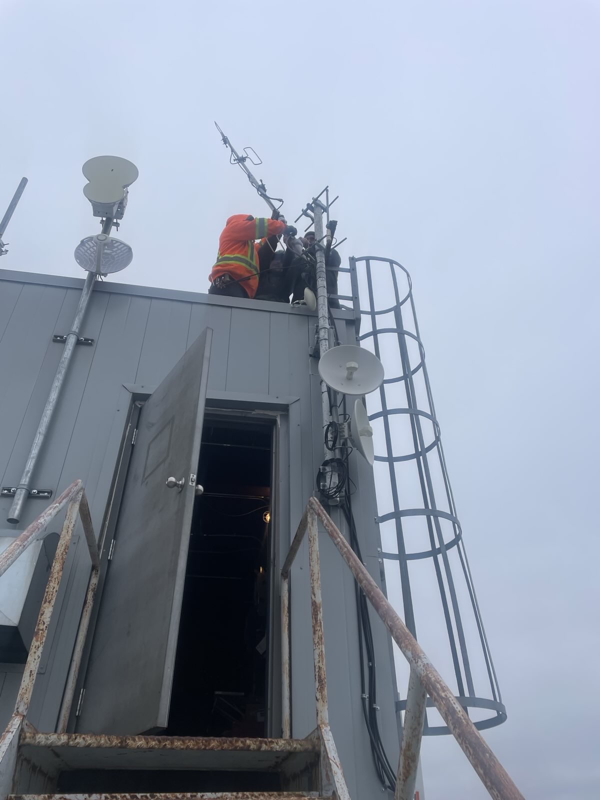 Crew reinstalling VE4WRS VHF antenna